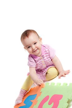 Shot of little cute baby playing with letters