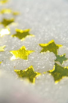 golden snow stars on a real snowy icy surface