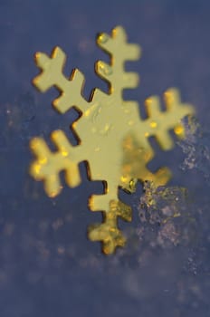 golden snow stars on a real snowy icy surface