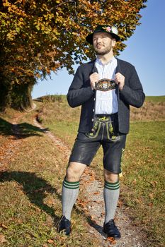 A traditional bavarian man in the autumn nature