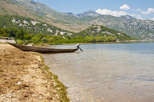 Small wooden boat, sandy beach, Skadarsko lake - Montenegro.
