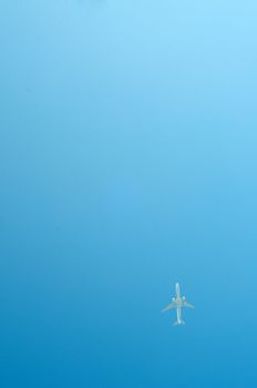 Small airplane on blue sky flying high