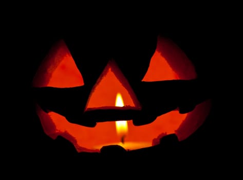 A scary Halloween pumpkin on black