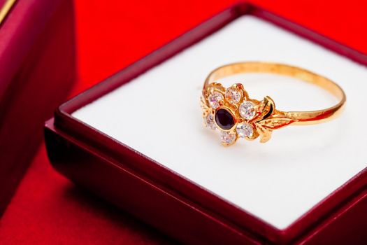Fantastic gold ring adorned with one blue  and several white zirconia