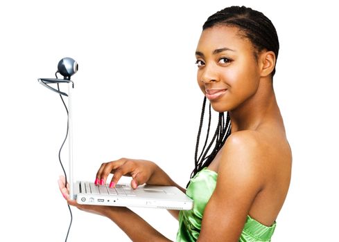 Portrait of a teenage girl using a laptop and smiling isolated over white