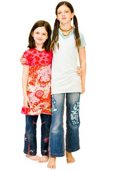 Portrait of two girls posing and smiling isolated over white