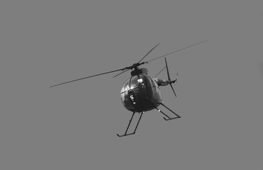 Small helicopter flying on a blue sky  (BW)