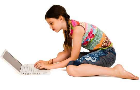 Beautiful girl using a laptop and smiling isolated over white