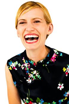 Laughing young woman posing isolated over white