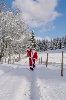 Santa Claus, Father Christmas in a beautiful winter landscape