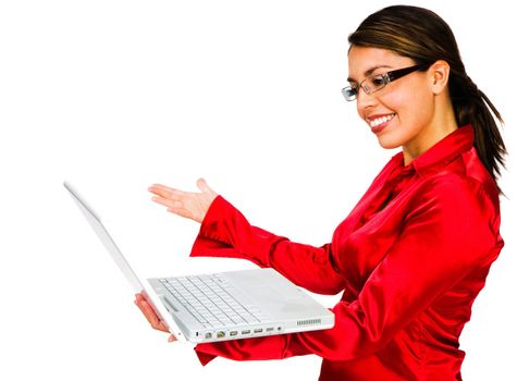 Latin American woman using a laptop and smiling isolated over white