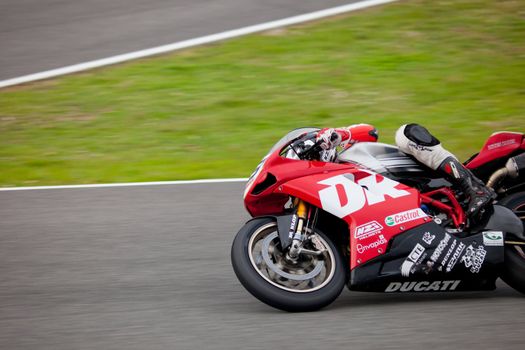 JEREZ DE LA FRONTERA, SPAIN - NOV 20: Stock Extreme motorcyclist Enrique Ferrer takes a curve in the CEV championship on Nov 20, 2010, in Jerez de la Frontera, Spain
