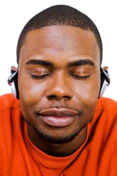 Smiling man wearing headphones and listening to music isolated over white