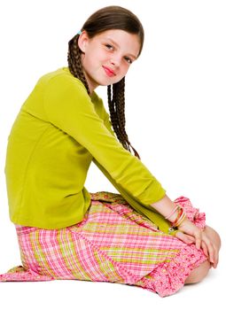 Smiling girl kneeling and posing isolated over white