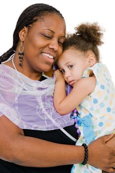 Smiling woman carrying her daughter isolated over white