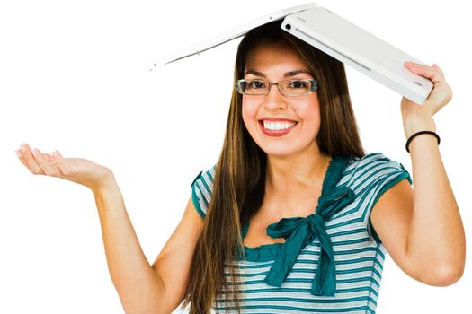 Woman holding laptop on her head and smiling isolated over white