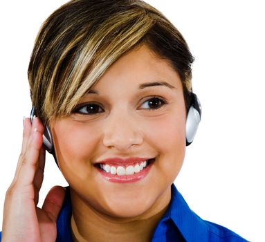 Beautiful woman wearing headphones and listening to music isolated over white