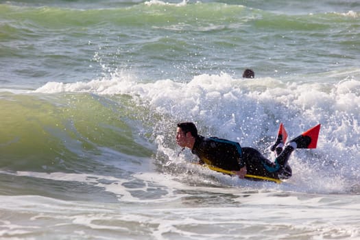 SAN FERNANDO, CADIZ, SPAIN - FEB 19: Unknown bodyboader taking waves on the 2nd championship of Surf and BodyBoard Impoxibol on Feb 19,2011 on the beach of Camposoto of San Fernando, Cadiz, Spain