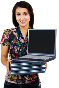 Portrait of a woman holding a stack of laptops isolated over white