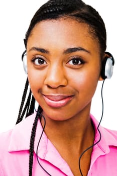 Confident teenage girl listening to music on headphones isolated over white