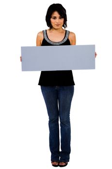 Latin American woman showing an empty placard isolated over white