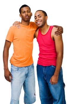 Portrait of two happy friends posing together isolated over white