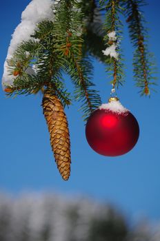 red bauble christmas ball ornament outside in a snowy winter scene