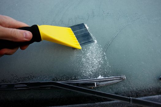 car windshield covered with ice and snow