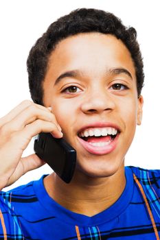 Teenage boy talking on a mobile phone isolated over white