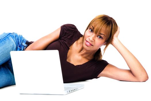 Woman lying on the floor and using a laptop isolated over white