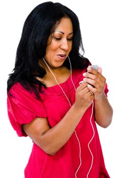 Confident woman listening to music on MP3 player isolated over white