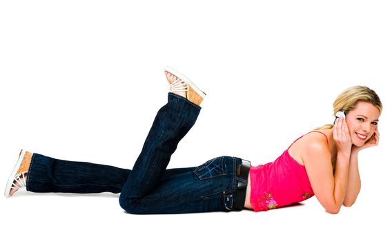 Fashion model listening to music with headphones isolated over white