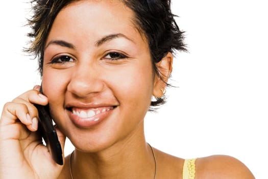 Woman talking on a mobile phone and smiling isolated over white