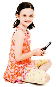 Smiling girl text messaging on a mobile phone isolated over white