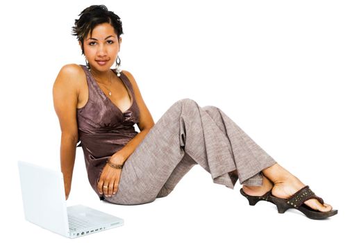 Portrait of a young woman using a laptop isolated over white