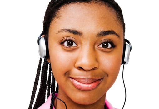 African teenage girl listening to music on headphones isolated over white