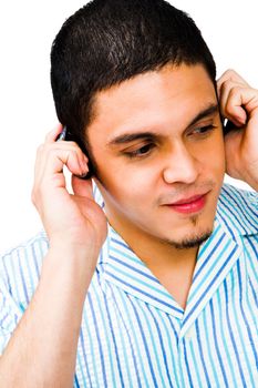 Young man listening to headphones isolated over white