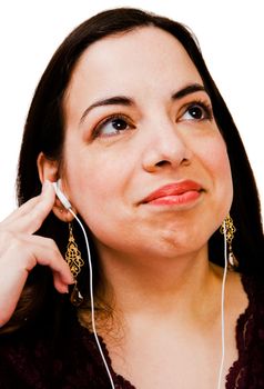 Happy woman listening to music on a MP3 player isolated over white