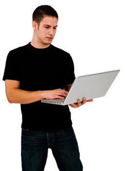 Latin American man using a laptop and posing isolated over white