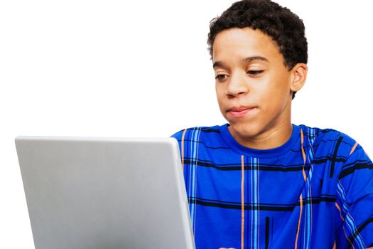 Teenage boy looking at a laptop isolated over white