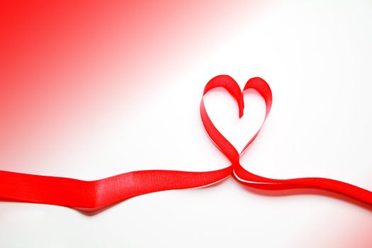 a ribbon forming a heart on a white background