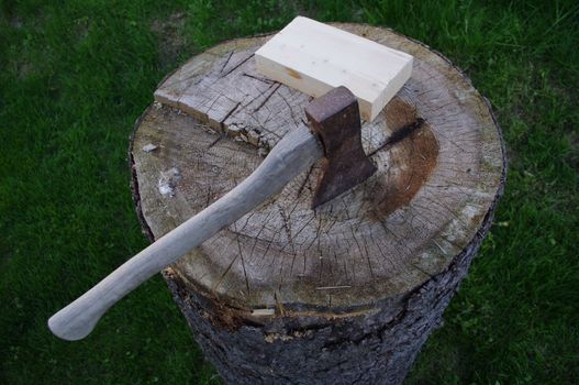 a axe on a stump of wood