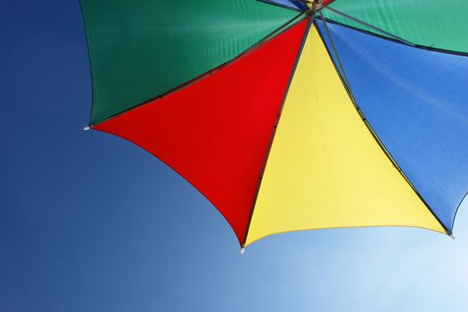 colorful parasol at the ocean on a sunny day