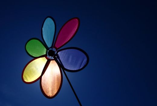 A colorful pinwheel set against a blue sky