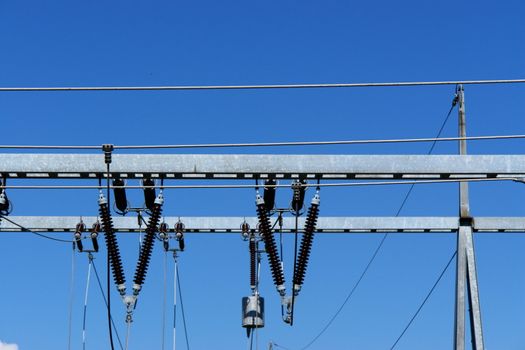 a utiliy pole against a blue sky