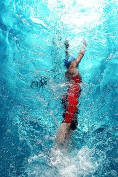 Swimmer in a swimming pool on a hot day