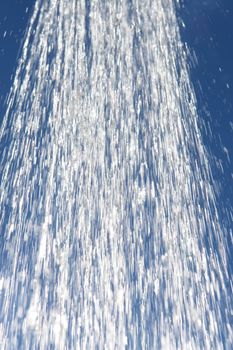 water drops falling from a shower outside