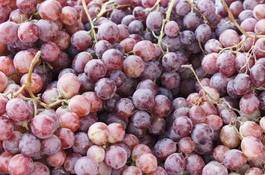 Pile of red grapes background in a street market