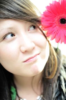 young asian girl with flower ? close-up portrait