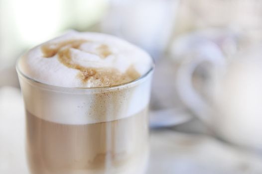 A glass with  cappuccino and whipped cream